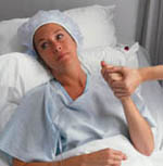 Picture of a woman, distressed, in a hospital bed