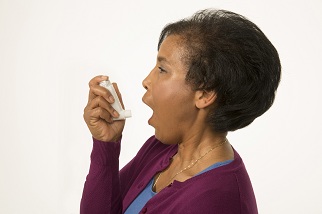 Woman holding inhaler, preparing to use it